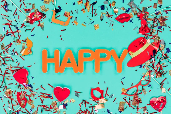 Happy sign surrounded with confetti — Stock Photo