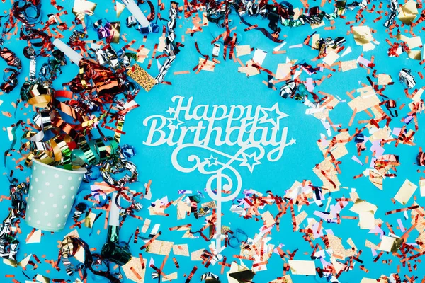 Happy birthday sign surrounded with confetti — Stock Photo