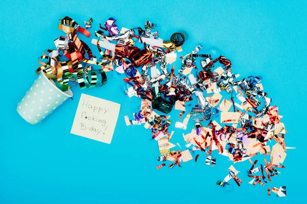 Confetti pouring from paper cup — Stock Photo