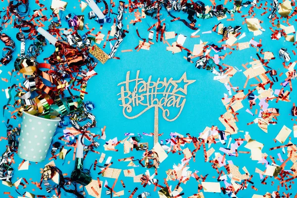 Happy birthday sign surrounded with confetti — Stock Photo