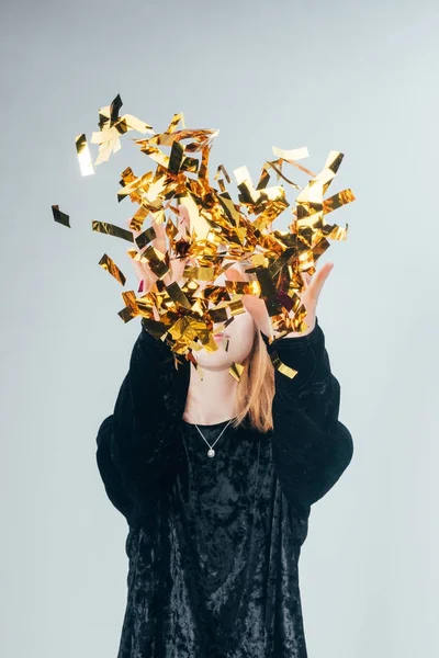 Woman throwing up confetti — Stock Photo