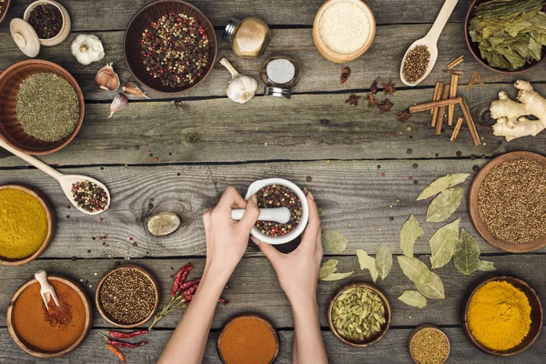 Woman grinding pepper — Stock Photo