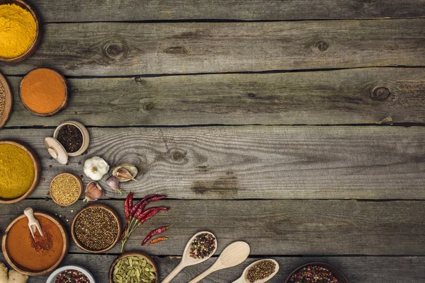 Spices in bowls and spoons — Stock Photo