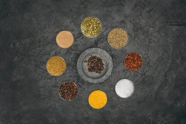 Round of glass bowls with different spices — Stock Photo