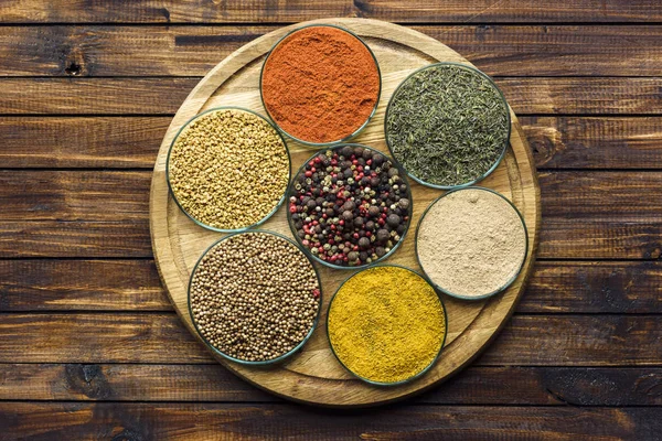 Glass bowls with different spices — Stock Photo