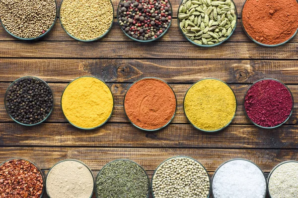 Glass bowls with different colorful spices — Stock Photo