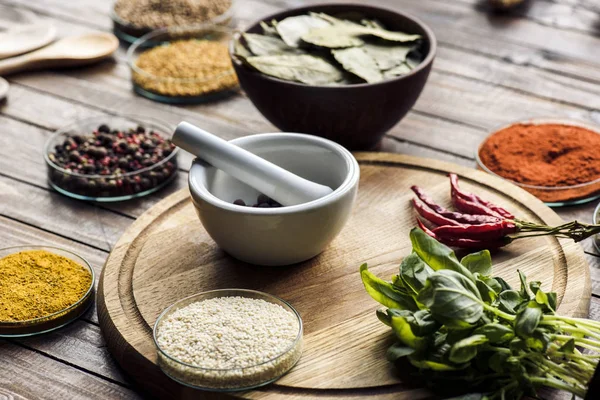 Pestle and mortar with basil and chili peppers — Stock Photo