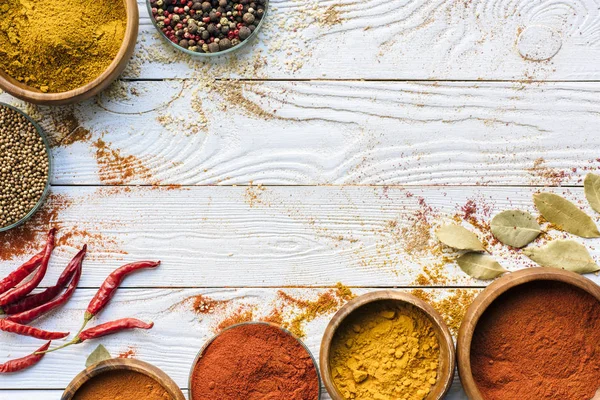 Scattered spices and glasses with spices — Stock Photo