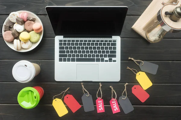 Laptop and sale tags — Stock Photo