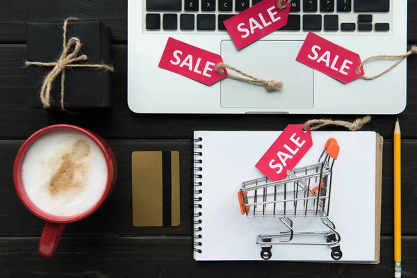 Laptop, credit card and sale tags — Stock Photo