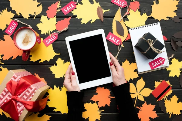Tablet with presents and sale tags — Stock Photo