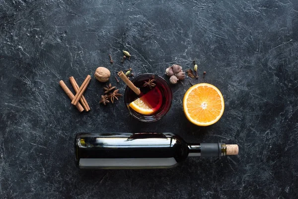 Wine bottle and glass with mulled wine — Stock Photo