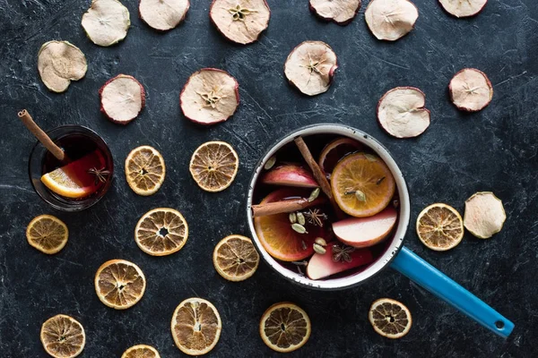 Water dipper and glass with mulled wine — Stock Photo