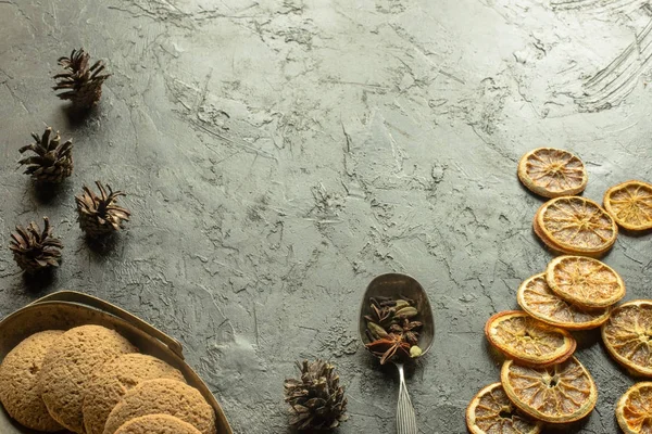 Dried oranges with cookies and pine cones — Stock Photo