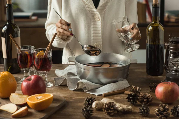Woman pouring homemade mulled wine — Stock Photo