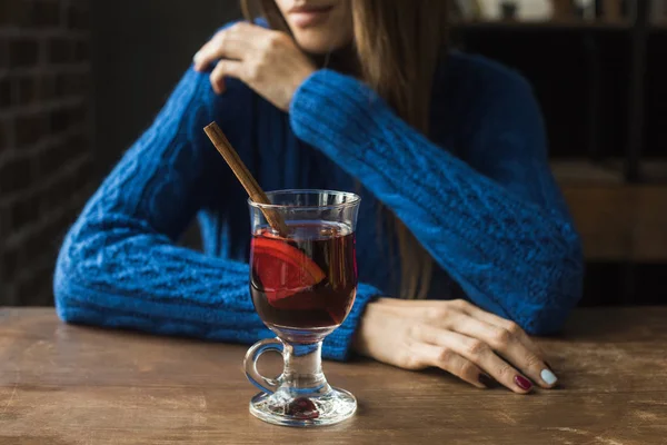 Woman sitting with glass of mulled wine — Stock Photo