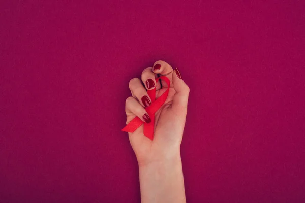 Hand with aids ribbon — Stock Photo