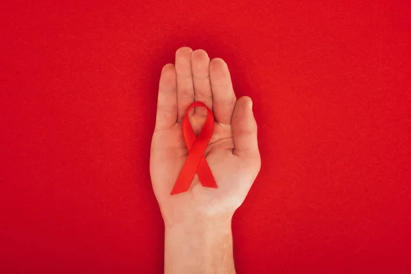 Hand with aids ribbon — Stock Photo