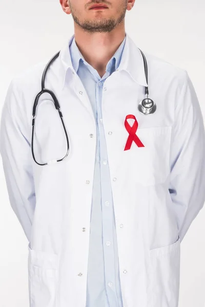 Doctor with stethoscope and aids ribbon — Stock Photo