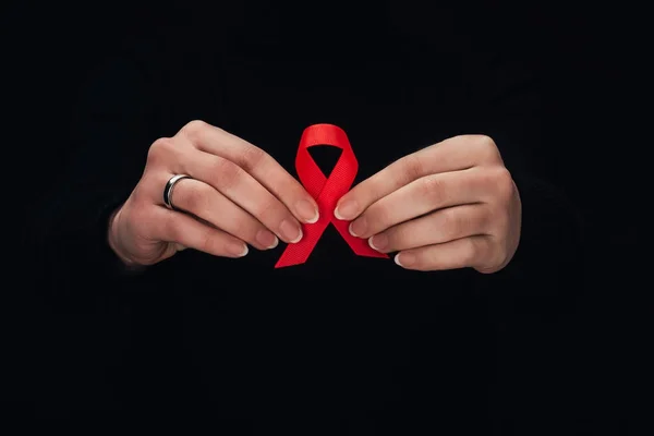 Woman holding red aids ribbon — Stock Photo