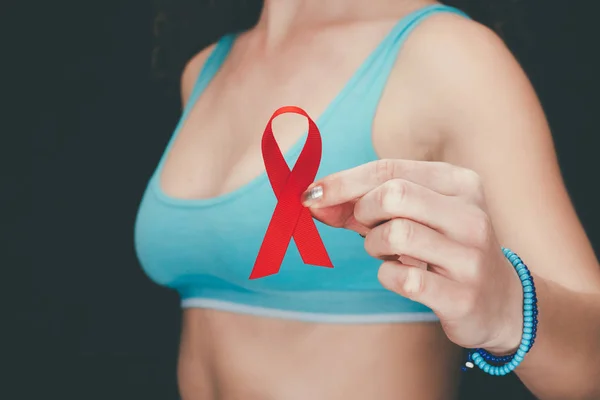 Woman with red aids ribbon — Stock Photo