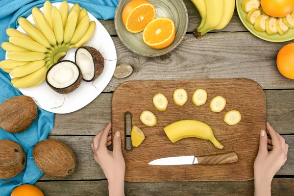 Personne tranchant la banane — Photo de stock