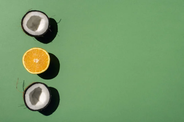 Halved coconut and orange — Stock Photo