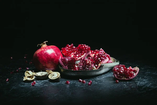 Pomegranates in metal bowl — Stock Photo