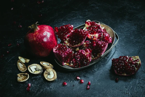 Pomegranates in metal bowl — Stock Photo