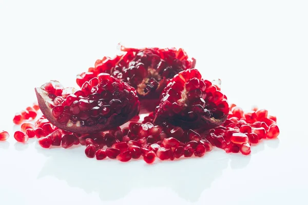 Ripe pomegranate with scattered seeds — Stock Photo