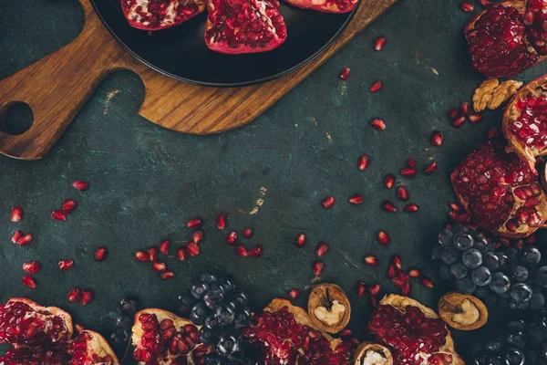 Pomegranates and grapes — Stock Photo