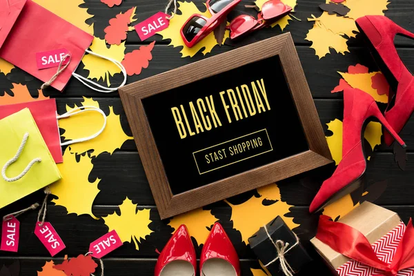 Blackboard, sale tags and foliage — Stock Photo