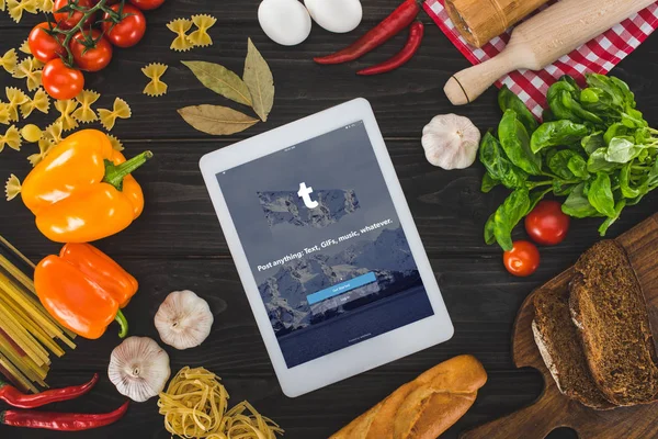 Digital tablet and fresh ingredients — Stock Photo