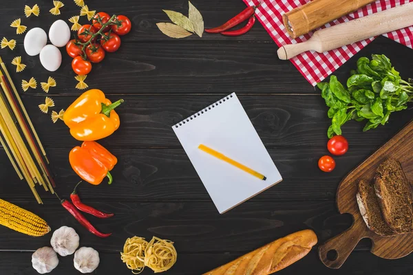 Ingredients and blank notebook — Stock Photo