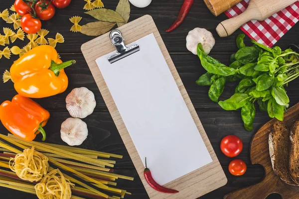 Sheet of paper on clipboard and ingredients — Stock Photo