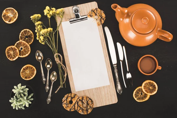 Blank paper on clipboard and cookies — Stock Photo