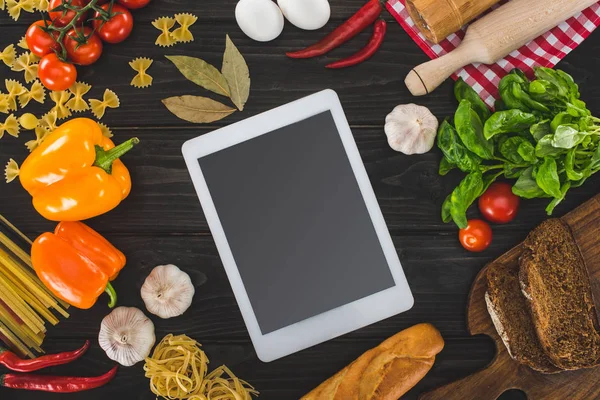 Digital tablet and fresh ingredients — Stock Photo