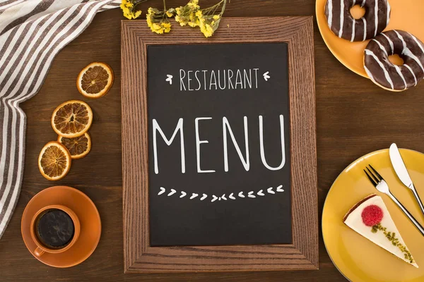 Restaurant menu and pastries — Stock Photo