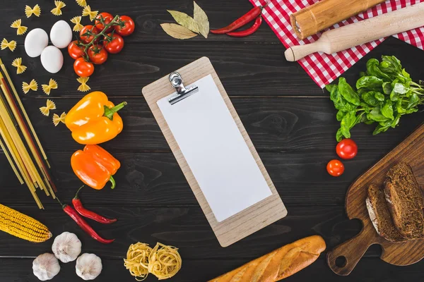 Sheet of paper on clipboard and ingredients — Stock Photo