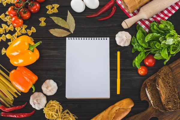 Ingredients and blank notebook — Stock Photo