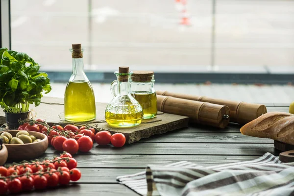 Olive oil bottles with vegetables — Stock Photo