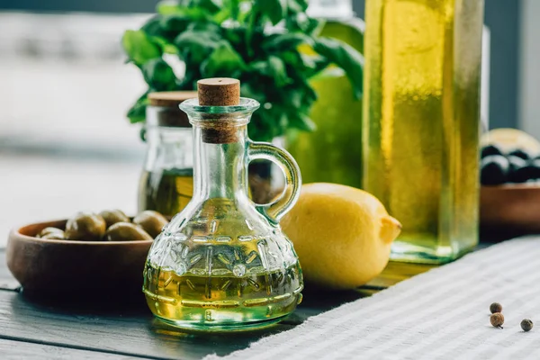 Olive oil bottles with vegetables — Stock Photo