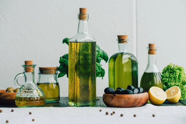 Olive oil bottles with vegetables — Stock Photo