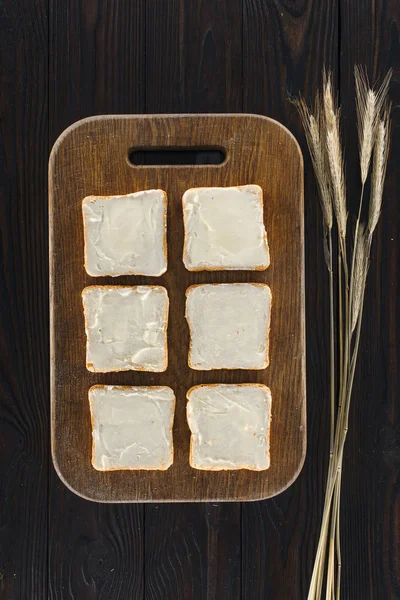 Toasts with butter and spikelets — Stock Photo