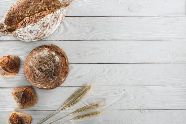 Loaves of bread and spikelets — Stock Photo