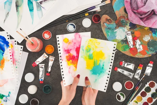 Painter looking at diluted paints — Stock Photo