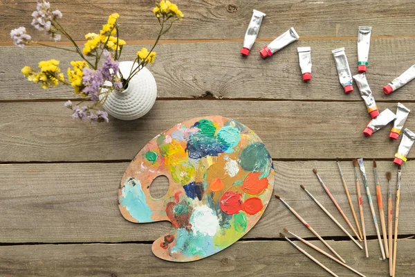 Palette with acrylic paints tubes — Stock Photo