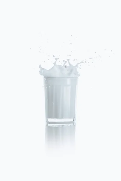 Splash of fresh milk in glass — Stock Photo