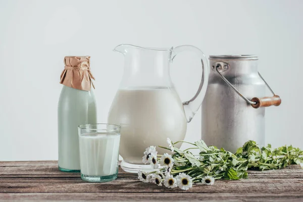 Jugs, bottle and glass of milk — Stock Photo