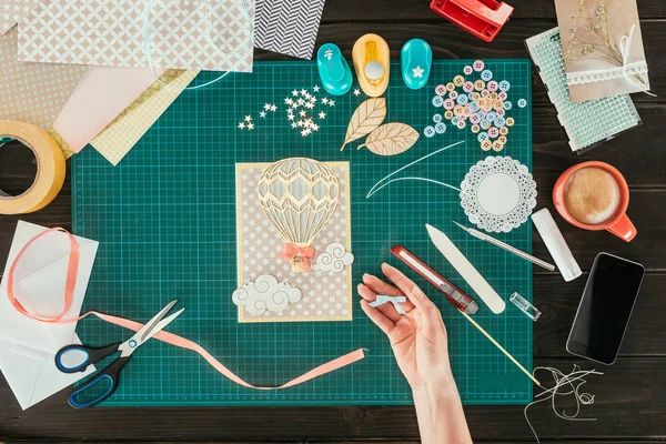 Cropped image of woman holding small decorative bow in hand — Stock Photo